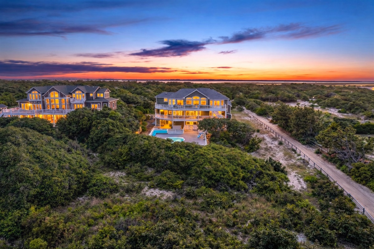 Commanding oceanfront presence — The Fitzgerald Estate at golden hour, showcasing three levels of luxury living with panoramic Atlantic views and lush coastal landscaping