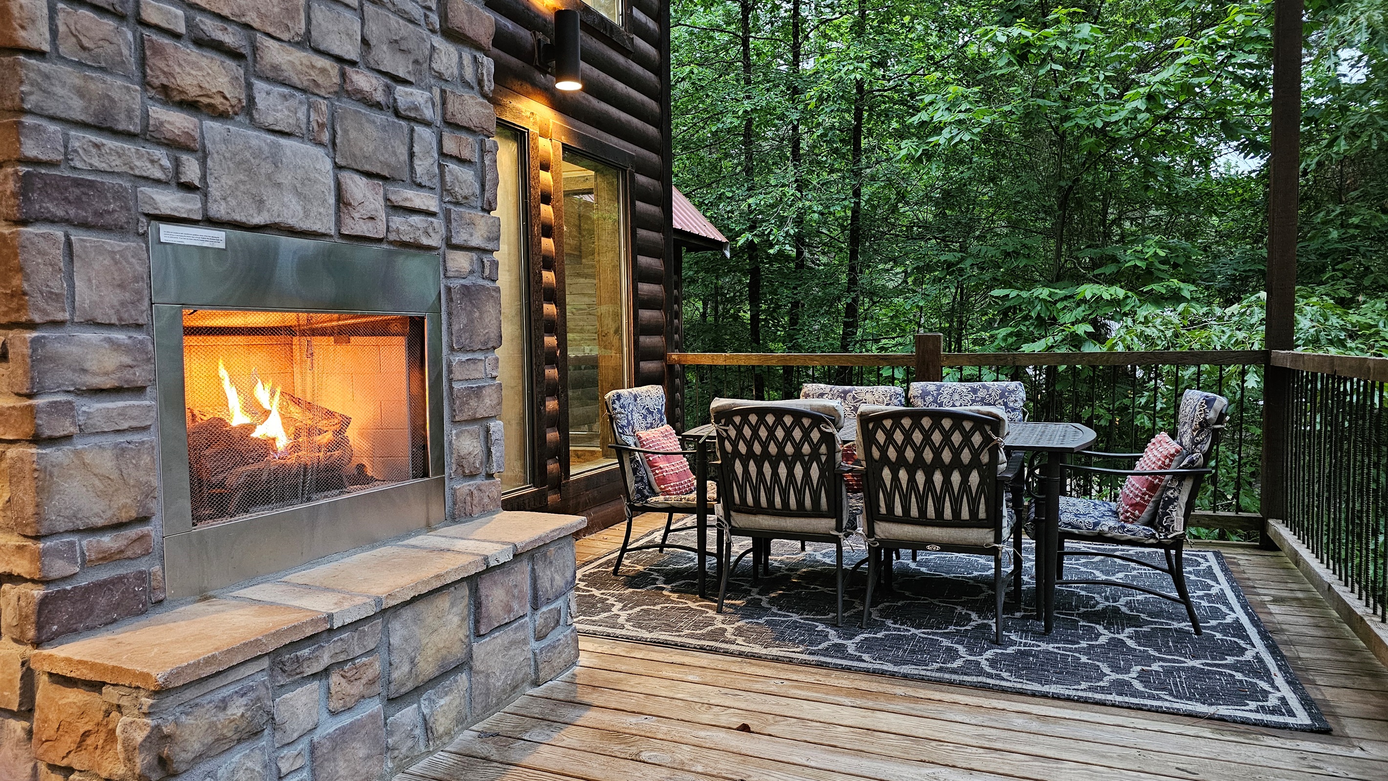 Outdoor Lounge: Unwind by the stone fireplace amidst nature's beauty on the spacious deck!