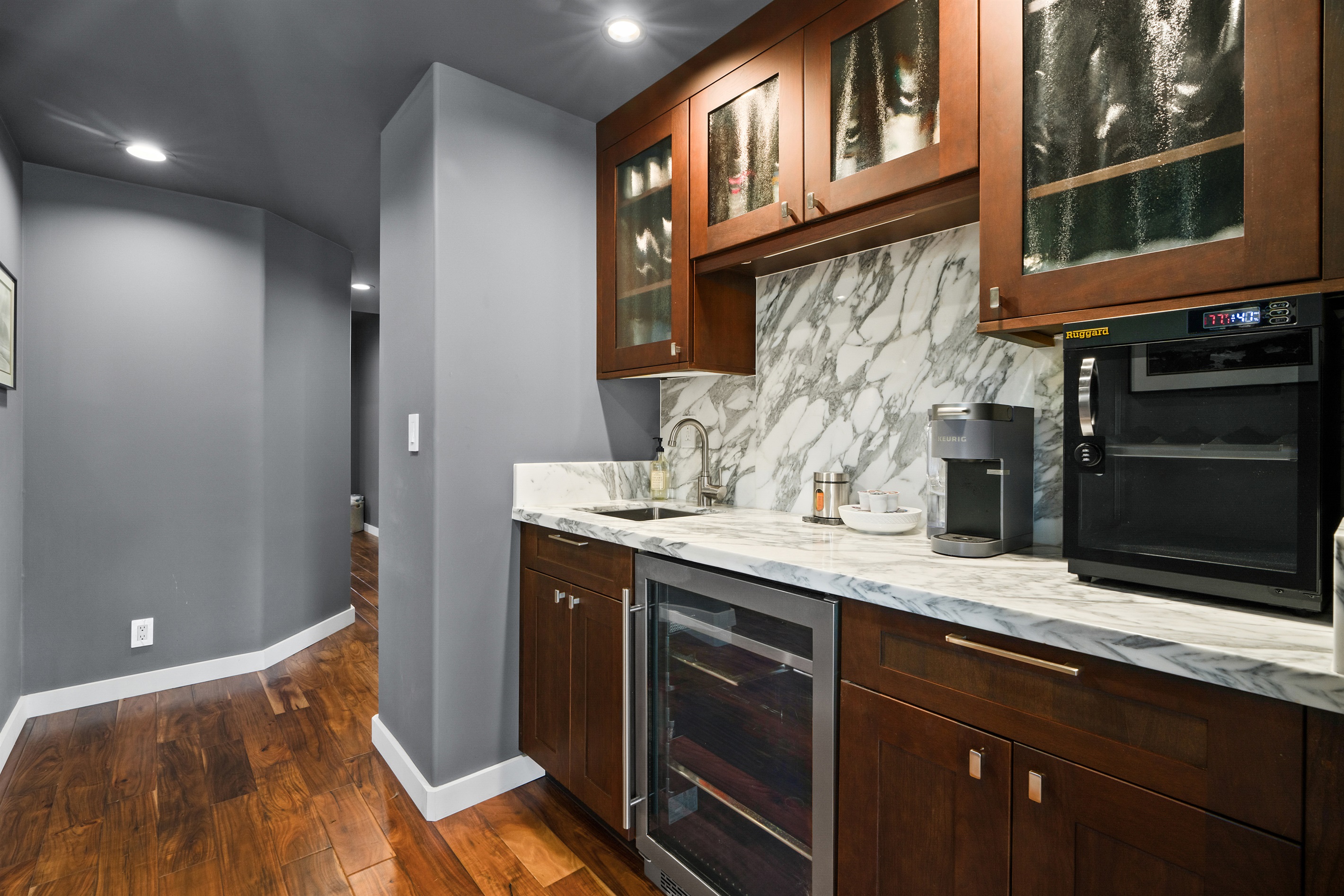 Wine bar with coffee maker, wine storage and electronic dehumidifier for camera gear.