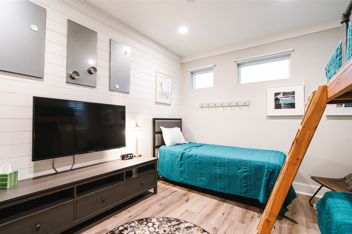 3 twin beds, bunk and single with a TV 