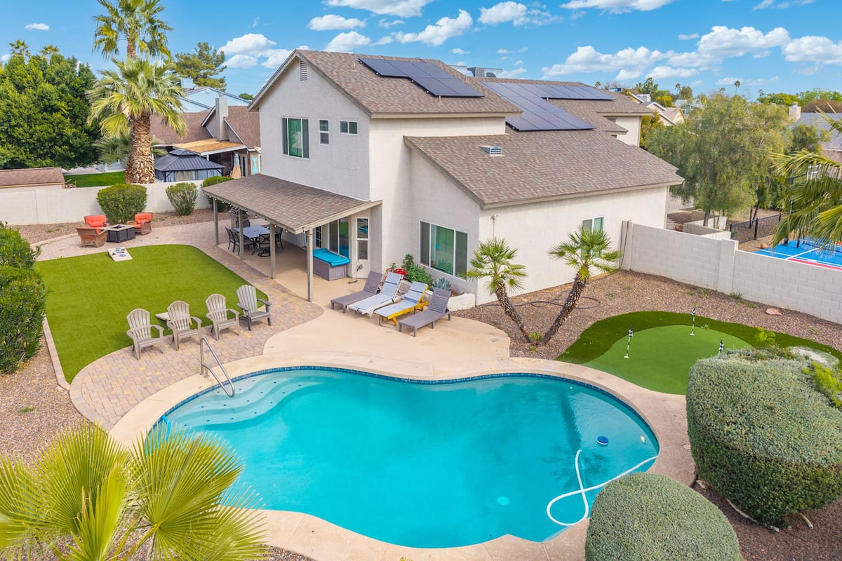 Stunning desert home with resort-style pool, solar panels, and manicured grounds perfect for groups.