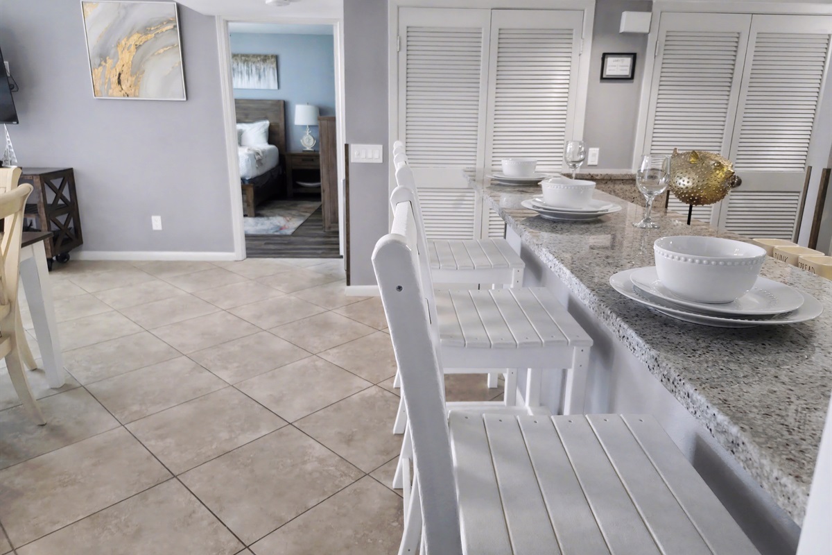 Counter seats with outdoor style seats by the kitchen and dining area