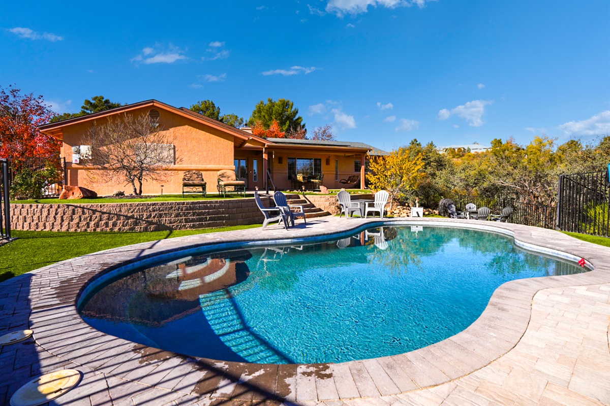 Sparkling private pool framed by the home and natural surroundings—your own resort-style escape.