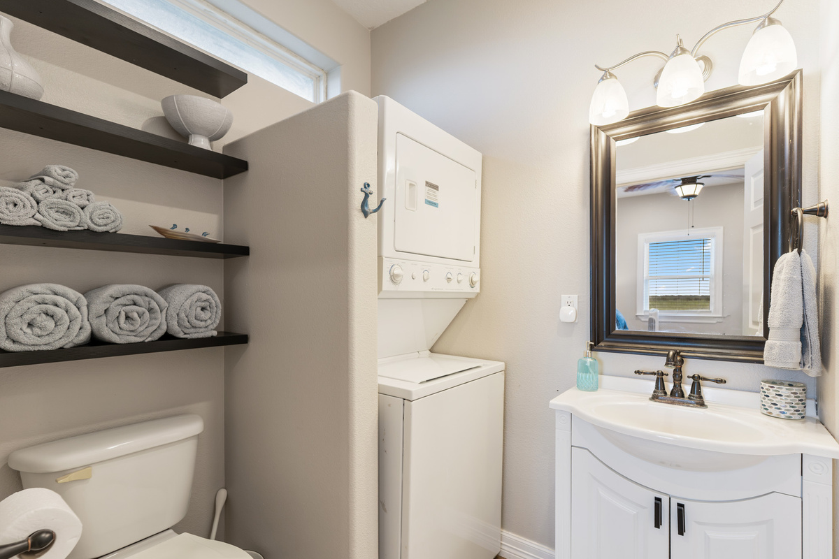 Primary bathroom with washer and dryer.