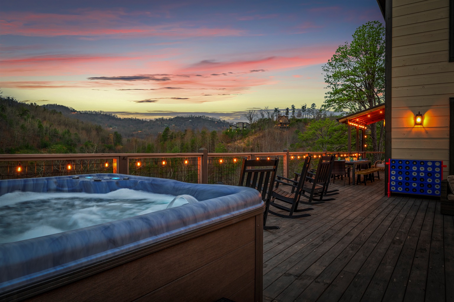 Unwind in the hot tub while watching the Smoky Mountain sunset as the deck lights begin to glow.