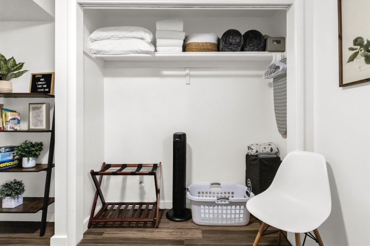 Closet in second bedroom showing extra pillows, blankets, towels and extra sheets. Pack and play (with sheets and blanket). Iron and iron board.