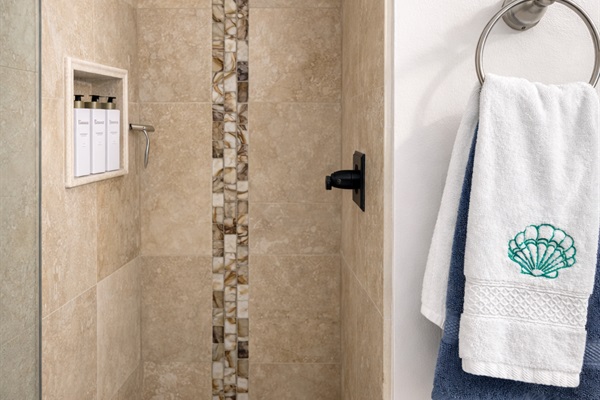 Walk-in shower with natural stone tile
