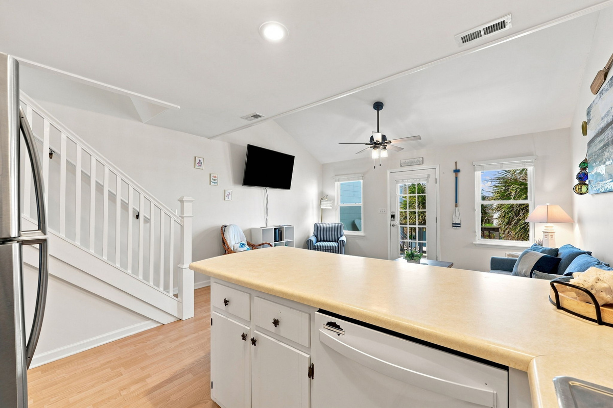 Bright, open-concept living space featuring a smart TV and easy access to the upper level.