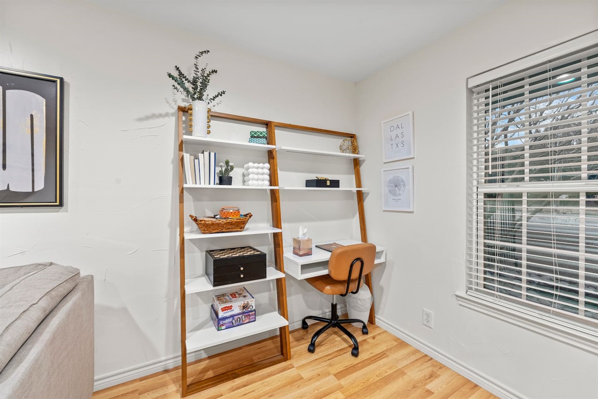 Stylish desk setup with shelving and natural light — ideal for getting work done while away from home.