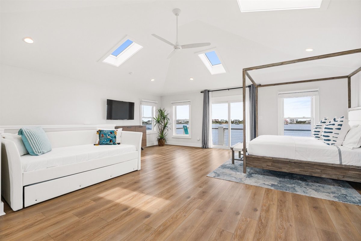 Bright and airy master suite with vaulted ceilings, skylights, and additional twin daybed with trundle