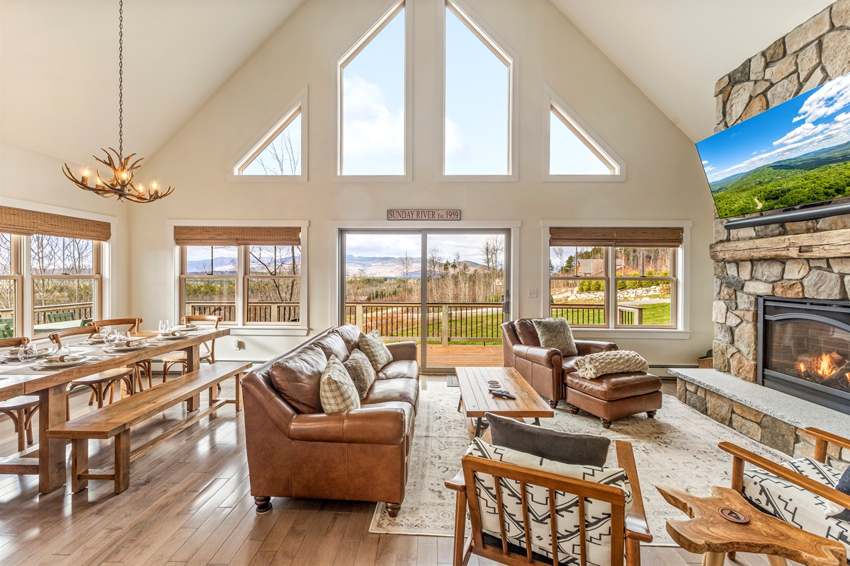 Open-concept main floor with plenty of space, mountain views, and a warm fireplace.