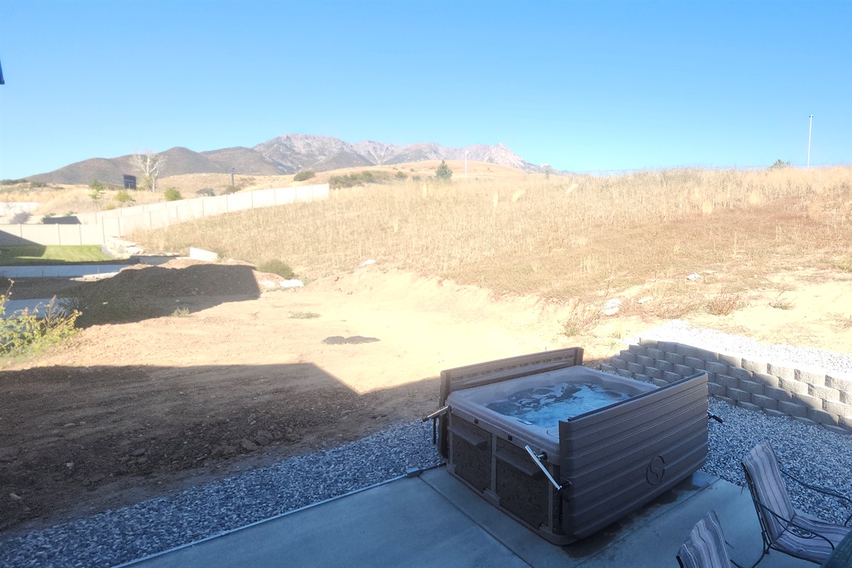 Gather with friends on the patio for mountain views, outdoor dining, and a soothing hot tub under the open sky.