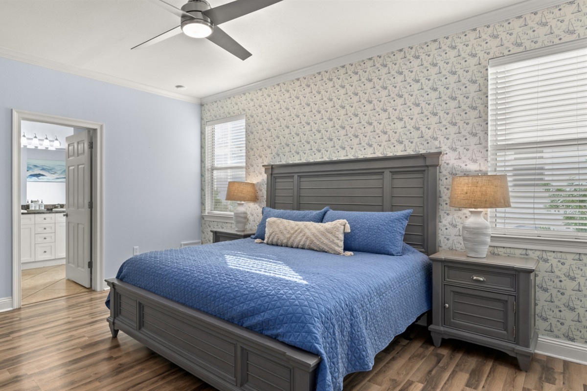 A king-bed retreat with sailboat wallpaper and an ensuite bath just steps away.