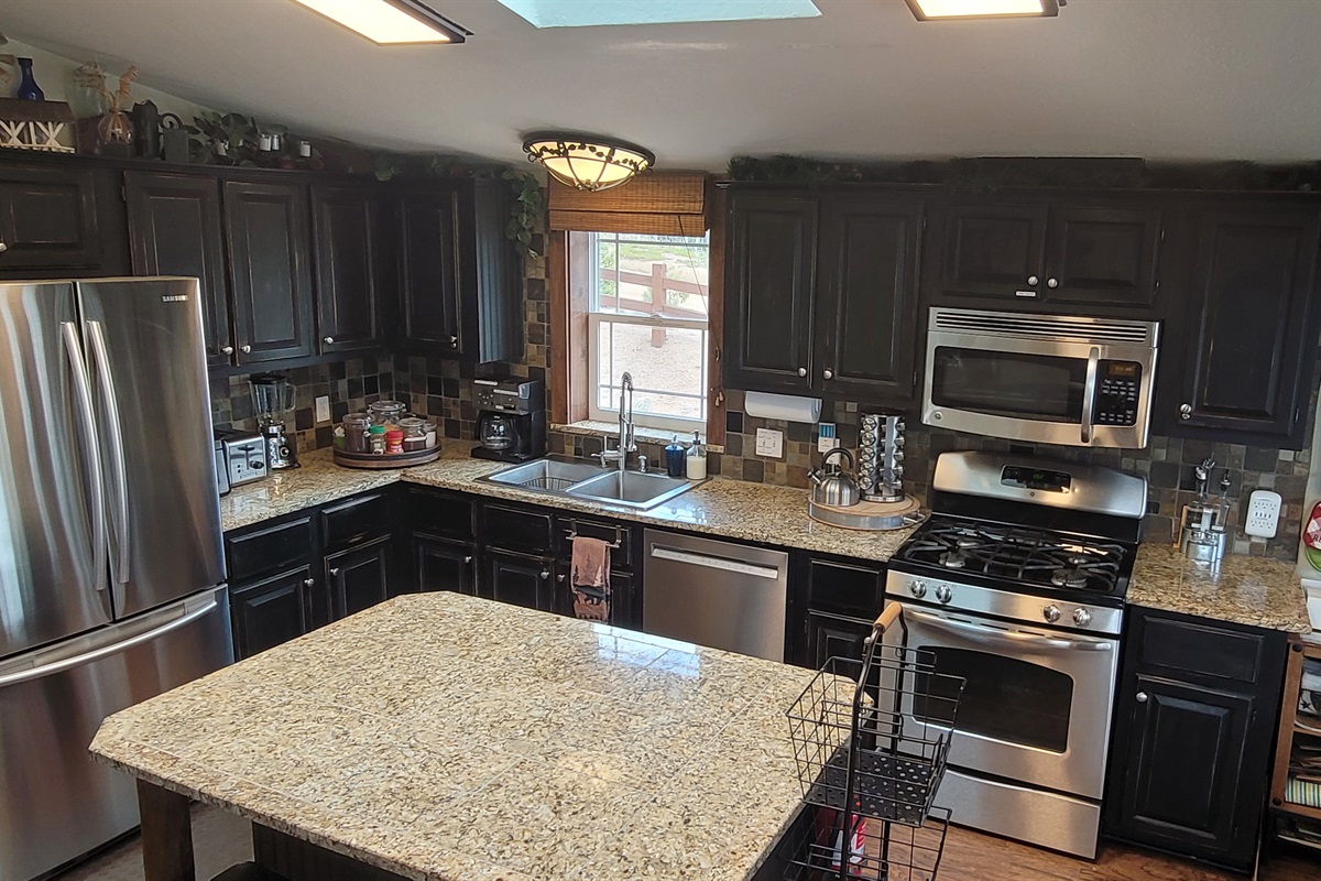 The Kitchen has high-end appliances: browning microwave, dishwasher,  gas stove & more.  It is stocked with cookware for any occasion, and an assortment of spices.