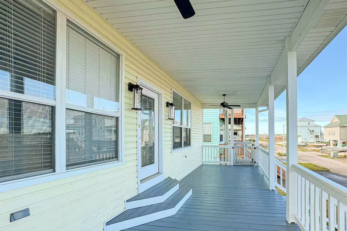 Spacious covered porch with ceiling fans and comfortable space to relax, enjoy fresh air, and unwind outdoors