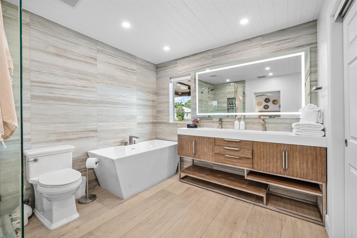 Designed with relaxation in mind, this bathroom blends natural materials and soft lighting for a serene, upscale experience.