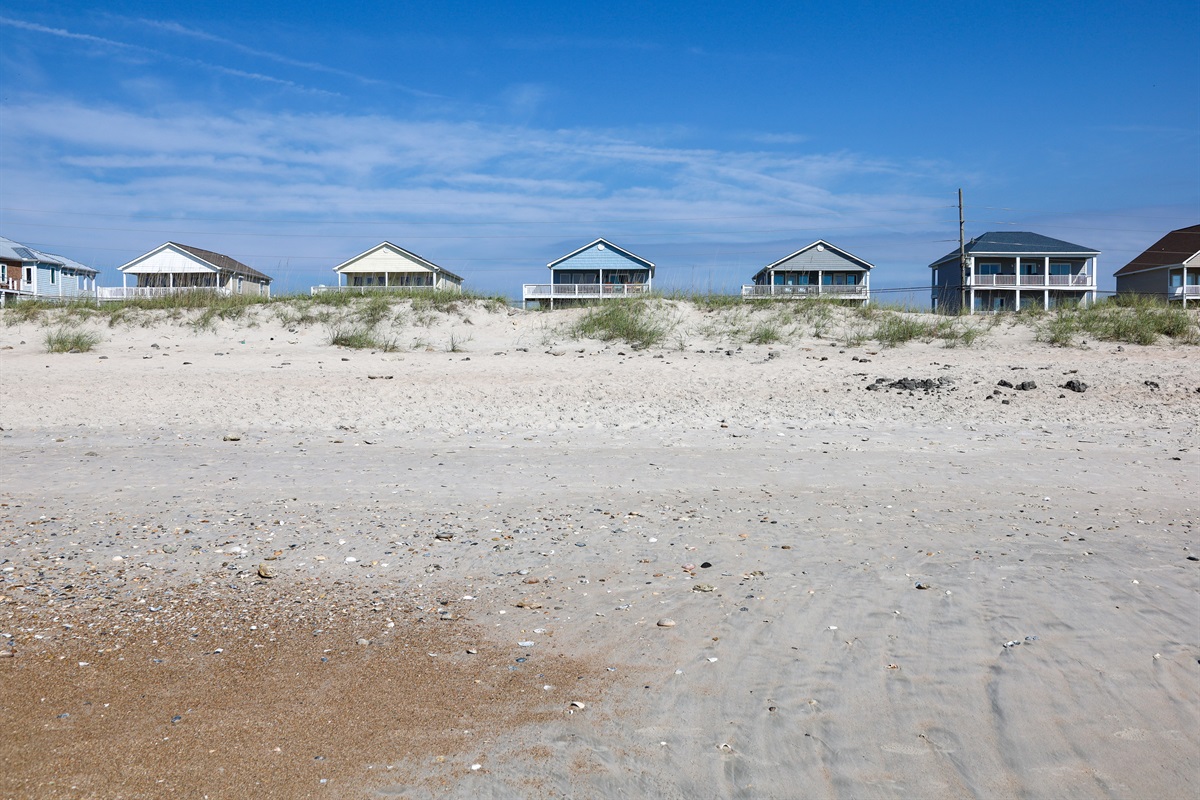 Colorful beach houses line the shore