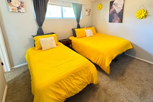 Double the Comfort, Double the Fun – Our bedroom boasts two single beds, a smart TV, and a spacious closet for a delightful stay.