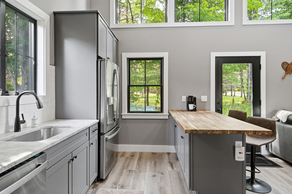 Bright modern finishes and large windows create an inviting space for cooking, dining, and gathering.