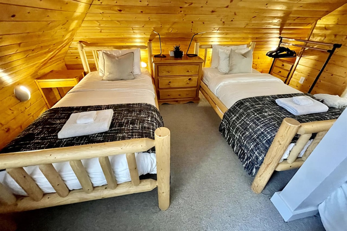 Top floor bedroom has a queen and two twin beds, ensuite bathroom w/ shower, TV lounge area and overlooks the Blackcomb Gondola base and mountain. 