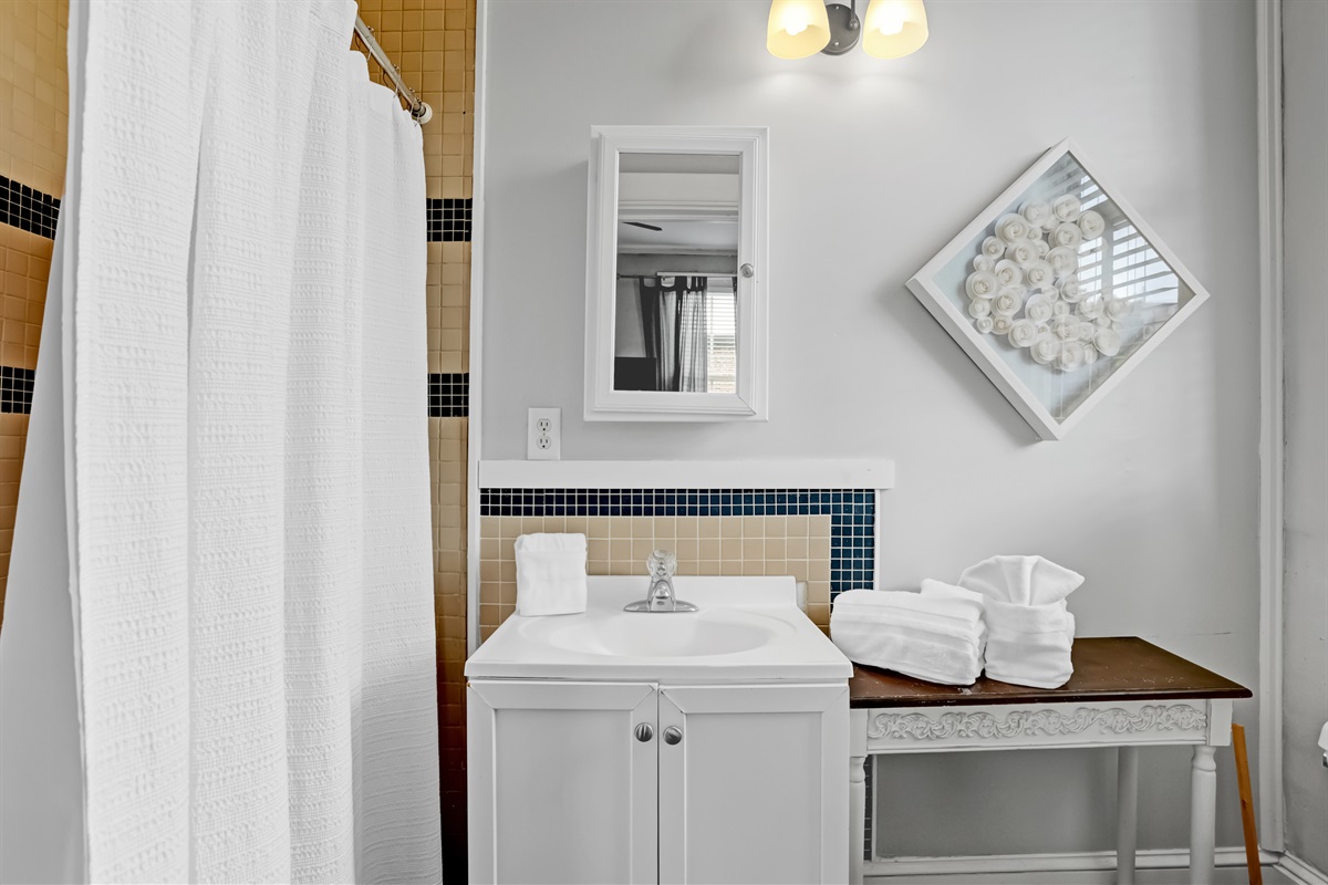 Modern ensuite bath with striking tilework and a spacious walk-in shower.