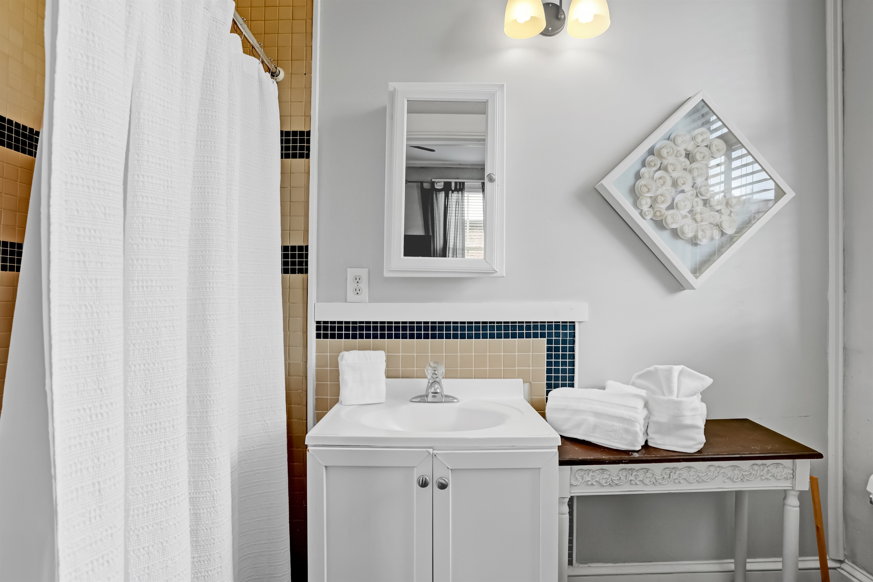 Modern ensuite bath with striking tilework and a spacious walk-in shower.
