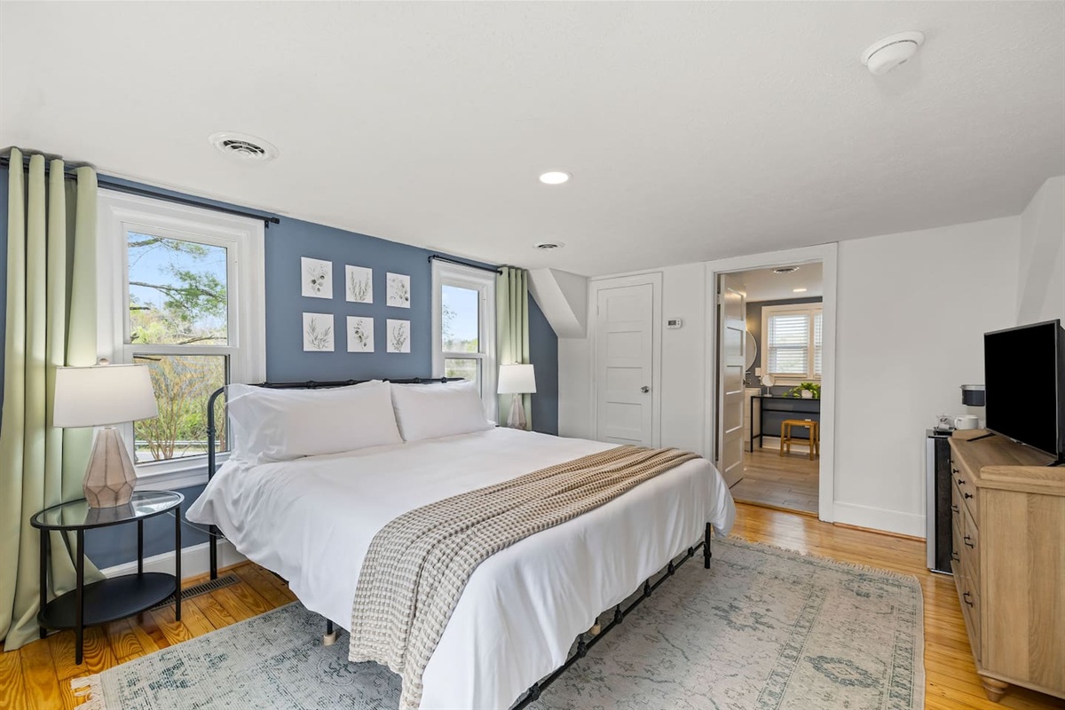 Magnolia Suite (Bedroom #6) includes king bed, dresser, TV, mini fridge + mini Keurig station and en-suite bathroom.