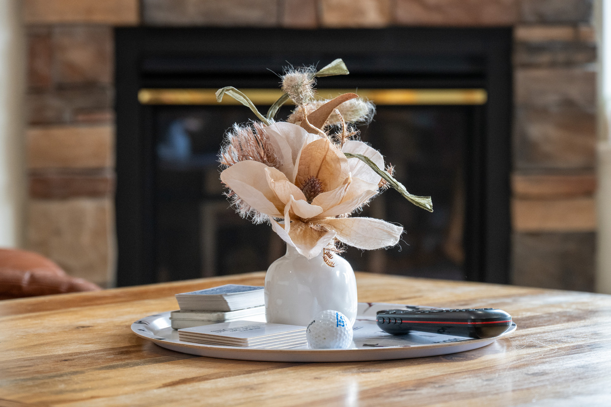 Cozy up by the fireplace with warm ambiance, stylish decor, and thoughtful touches throughout the condo.