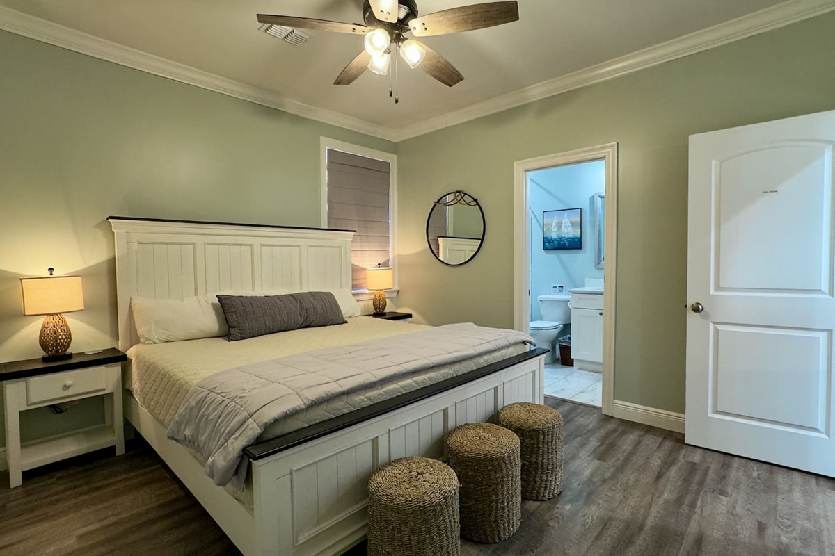 A bedroom that blends cozy textures with functional design, complete with ensuite bathroom.