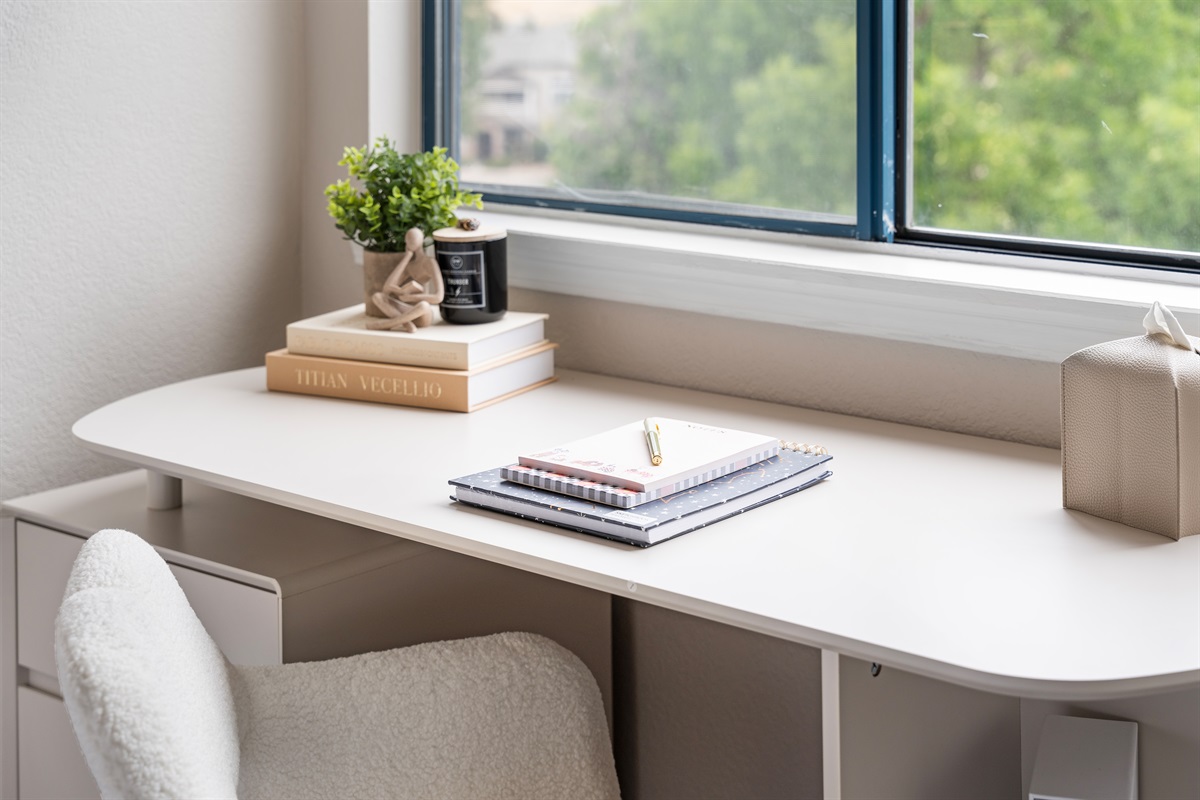 Full desk with plenty of space overlooking window
