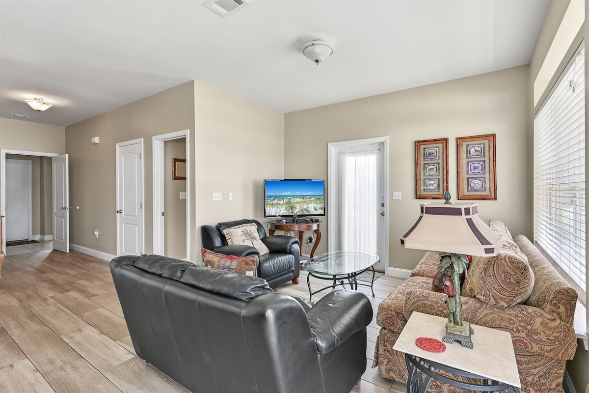 Living Room #1 (First Floor) – Sleeper sofa, loveseat, accent chairs & large TV