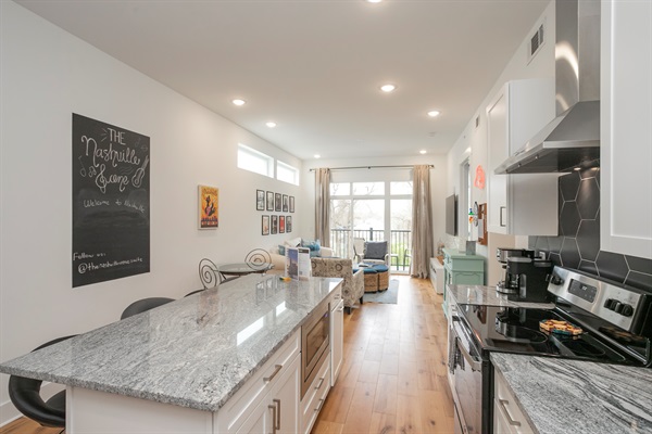 Plenty of room to enjoy charcuterie and dining at this large bar area in the kitchen
