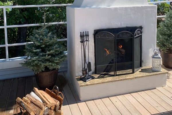 Newly built fireplace on the rooftop deck. It is a real wood-burning fireplace. It's available on a first come, first serve basis unless the space is otherwise reserved. Bring your own firewood or order delivery from us!