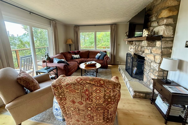 Living Room has a sectional sofa and two comfortable chairs in front of the gas log fireplace with amazing views. Need more seating? Pull over a dining chair, or send them to the game room! ;)
