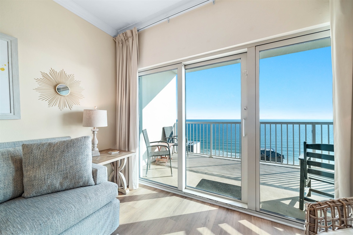 Experience the beauty of indoor-outdoor living with expansive sliding doors leading to a private balcony overlooking the ocean.