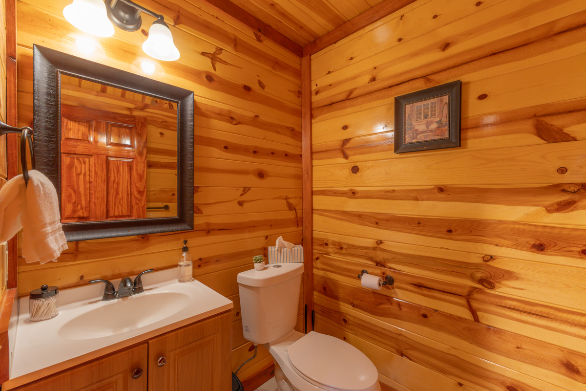 Located just down the hall from the pool room, this powder room adds extra convenience—because every guest appreciates plenty of well-appointed bathrooms.