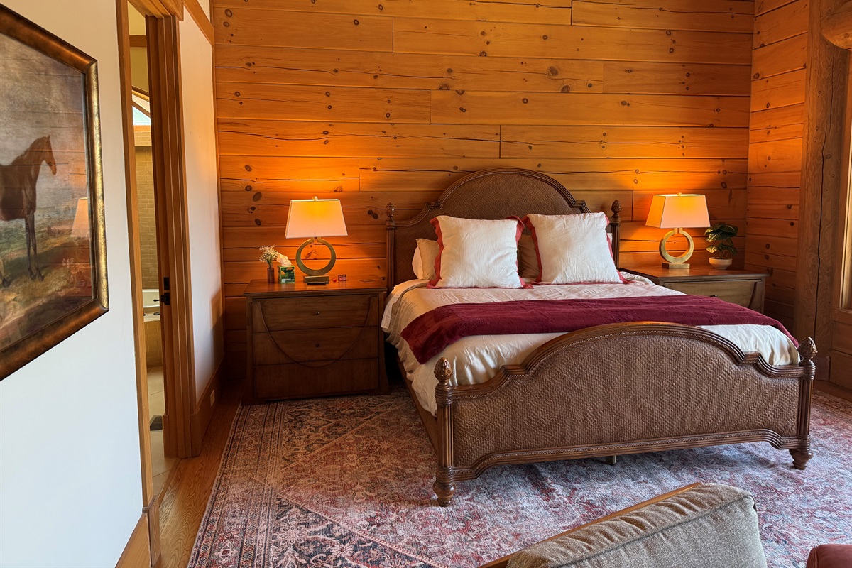 Spacious master bedroom featuring a comfortable king bed and a cozy propane fireplace