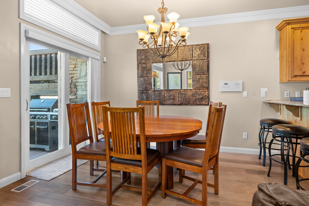 Gather around the dining table while enjoying easy access to the outdoor deck and grill.