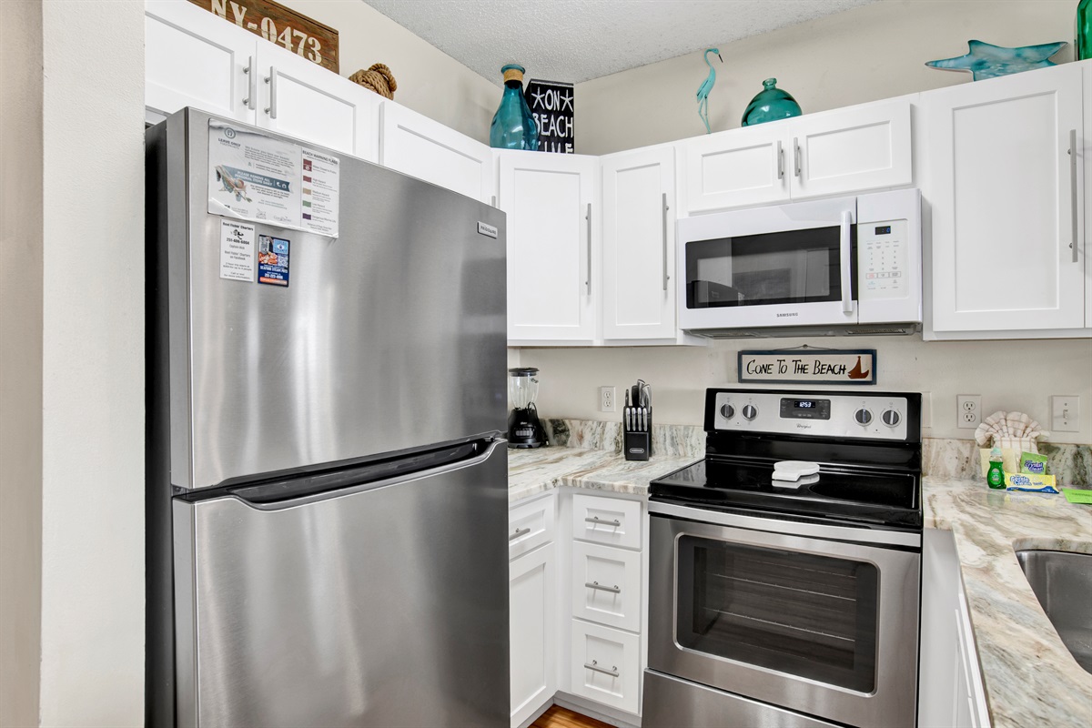 Kitchen with stainless steel appliances, granite tops and beautiful gulf view.
