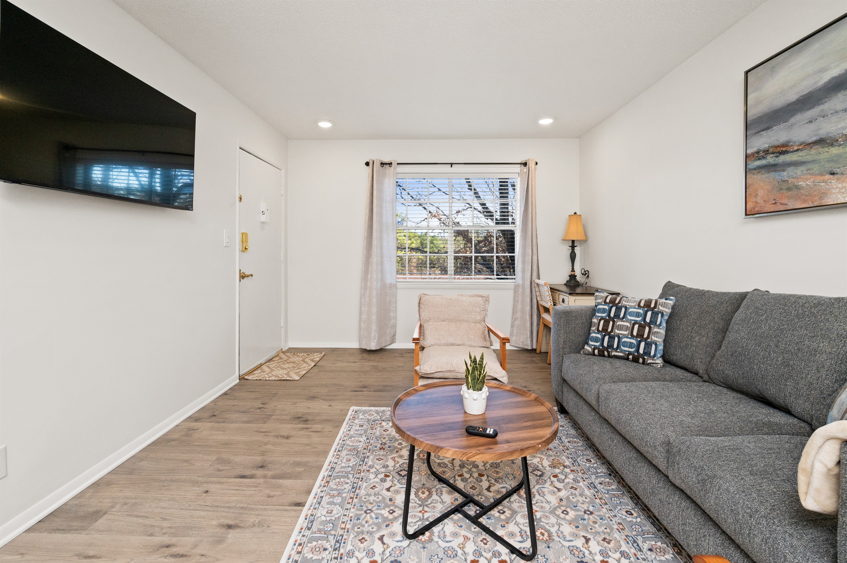 All living spaces - the bedrooms and living room - have smart TV's with streaming channels available! This is also a great view of the entry doorway.