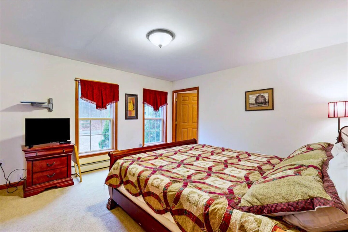 Main bedroom of the home with an attached full bathroom and king sized bed!