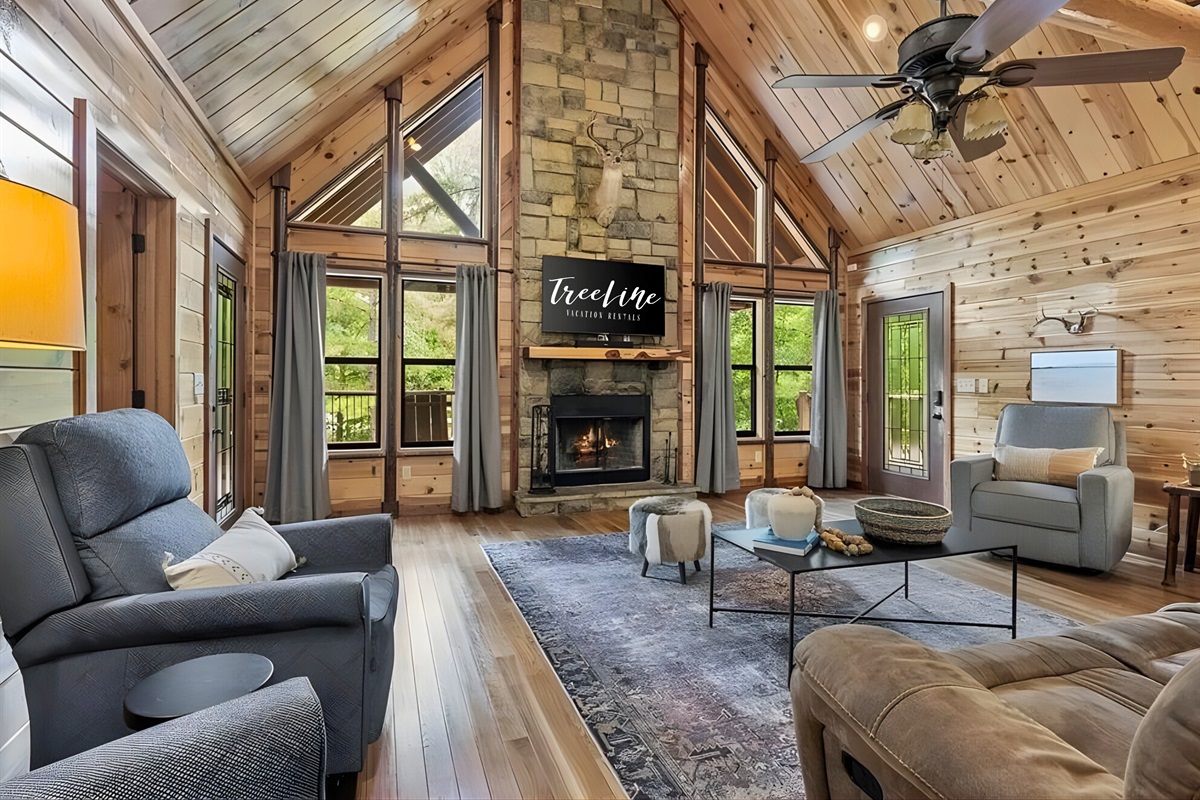 Vaulted ceilings and a stone fireplace create a warm, inviting living space.