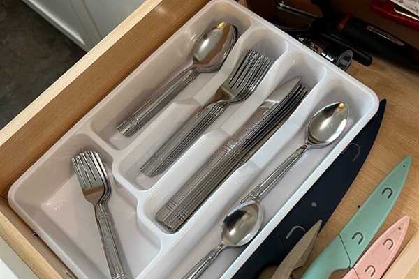 Fully equipped kitchen featuring sleek steel utensils and sharp knives, designed for efficient meal preparation. Combining style and functionality, this space is perfect for cooking and creating delicious meals with modern kitchen tools