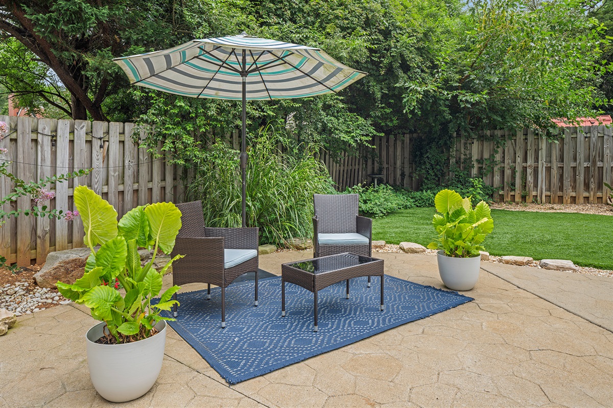 Outdoor Oasis: Enjoy leisurely afternoons under the umbrella in this charming patio retreat!