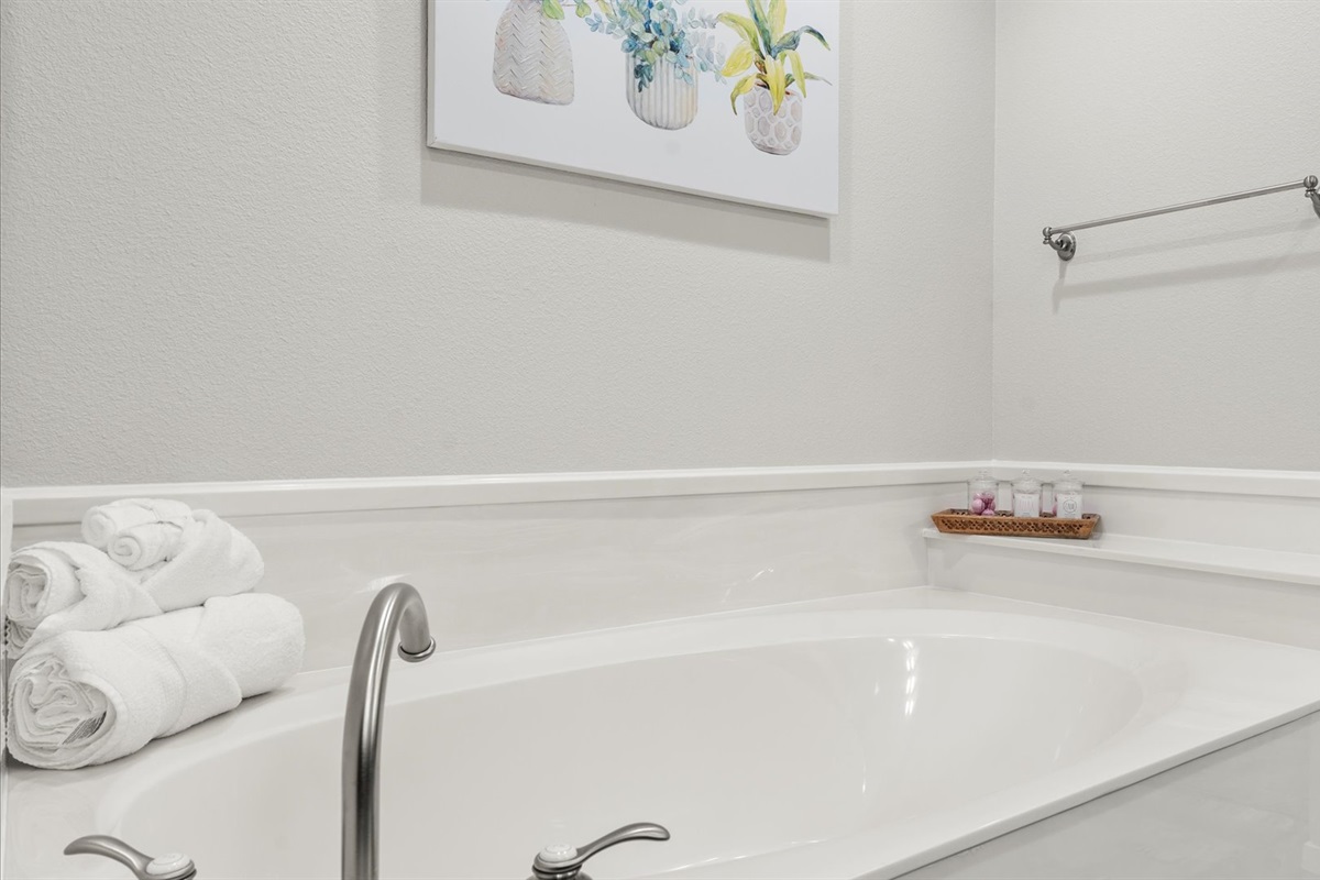 King 1 bathroom with large soaker tub, perfect for a relaxing spa-like bath experience. Large walk in shower. Unwind in comfort and enjoy the serene ambiance of this luxurious bathroom feature