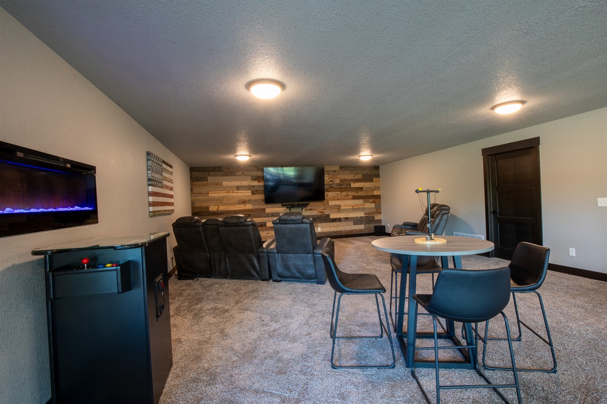The ultimate hangout spot—recline by the big screen, sip drinks by the electric fireplace, challenge friends at the arcade, or gather around the table for games and laughs.