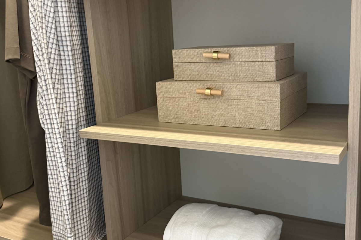 Unpack into a custom walk-in closet with built-in shelving and plush robes waiting on the rail.