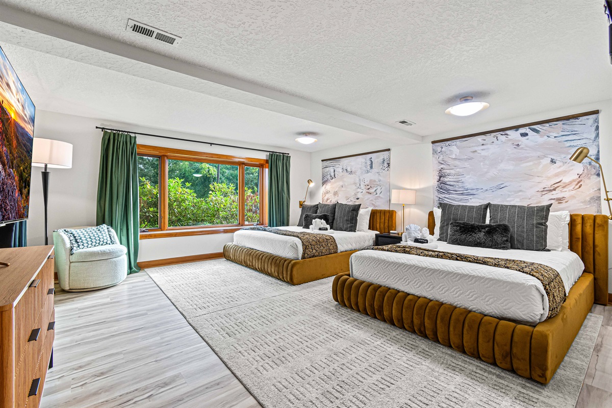 Retreat downstairs to the spacious lower-level River Arts Bedroom, where a king and queen bed offer plush comfort and mountain views—a cozy haven for couples or families sharing the space.🛏️🌿✨