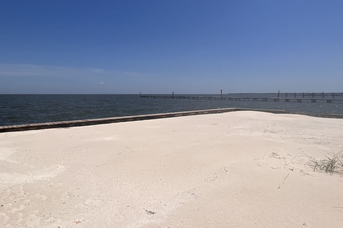 This private, secluded bayfront beach area offers an exclusive, tranquil retreat right at your doorstep, perfect for sunbathing or enjoying the scenic water views.