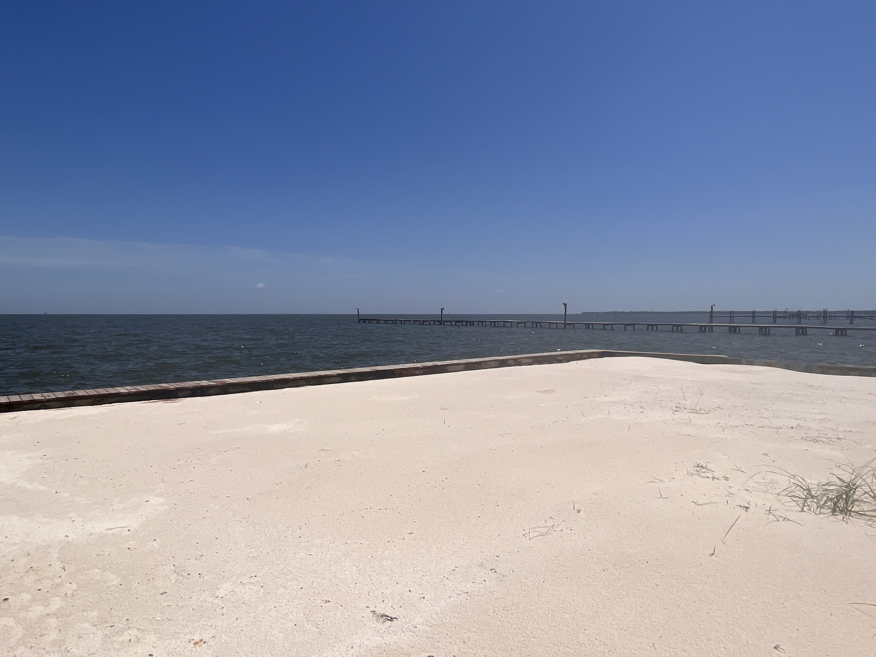 This private, secluded bayfront beach area offers an exclusive, tranquil retreat right at your doorstep, perfect for sunbathing or enjoying the scenic water views.